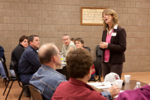 Leadership Recruitment Coordinator Becky Adams talks to a group of community leaders