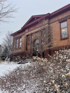 Front of the Two Harbors public library building with snow in the foreground