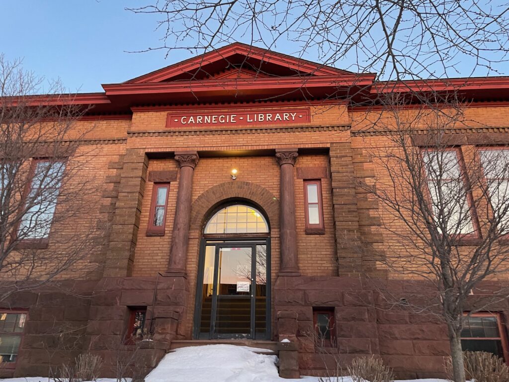 View of the front entrance to the library building, with blue sky above