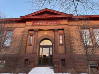 View of the front entrance to the library building, with blue sky above